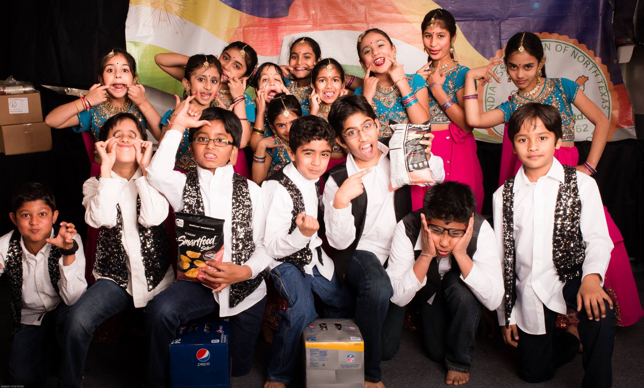 Noopur students sharing a playful backstage moment in costume