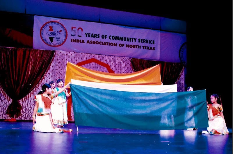 Noopur dancers on stage with a colorful fabric formation