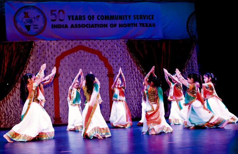 Noopur dancers in a large stage performance