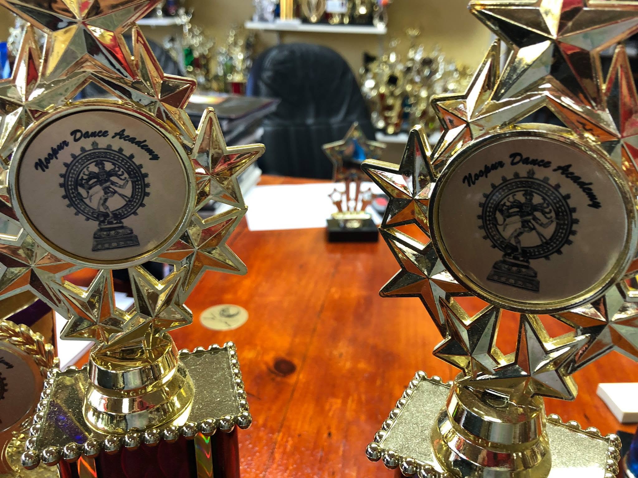 Noopur Dance Academy student trophies featuring the academy name