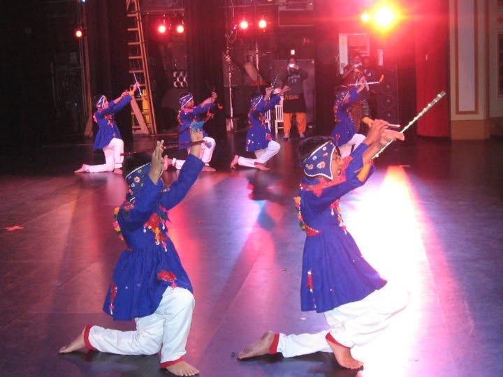 Noopur dancers in blue costumes on stage