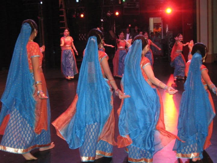 Noopur dancers in blue and orange costumes